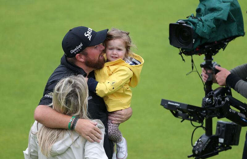 Lowry celebrates with wife Wendy Honner and kid. Richard Sellers / PA Wire