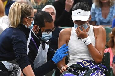 Emma Raducanu (R) of Britain receives medical assistance during her 4th round match against Ajla Tomljanovic of Australia at the Wimbledon Championships in Wimbledon, Britain, 05 July 2021.   EPA / FACUNDO ARRIZABALAGA   EDITORIAL USE ONLY