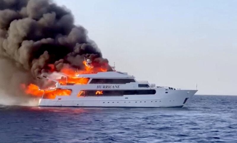 Flames leap from the boat on Sunday. Reuters