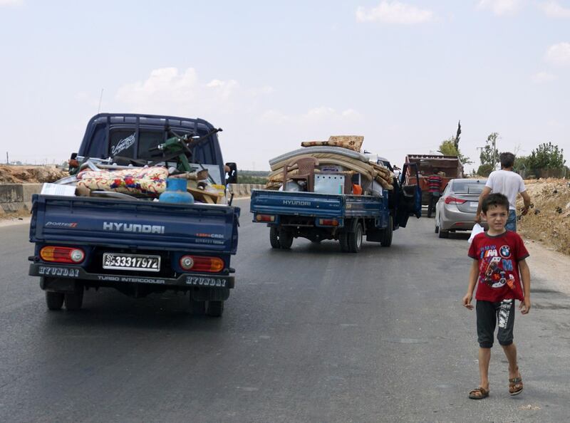 Syrians fleeing from the town of Maaret al-Numan and its surrounding countryside drive with their belongings northwards near the town of Saraqib in the northwestern Idlib province.  AFP