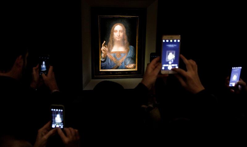 epa06382744 YEARENDER 2017 NOVEMBER 
People take pictures of the painting 'Salvator Mundi' by Leonardo da Vinci (circa 1500) during a public preview before an auctioning of the painting tonight at Christie's auction house in New York, New York, USA, 15 November 2017. The painting is reportedly one of only twenty paintings by Da Vinci and was sold for 450 million USD.  EPA/JUSTIN LANE