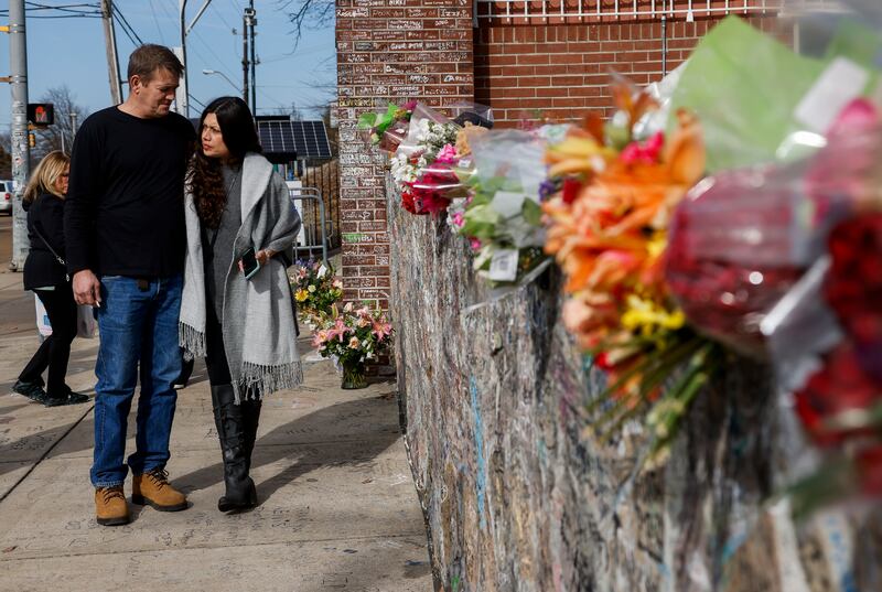 People walk along the sidewalk outside Graceland prior to a memorial service for Lisa Marie Presley. EPA