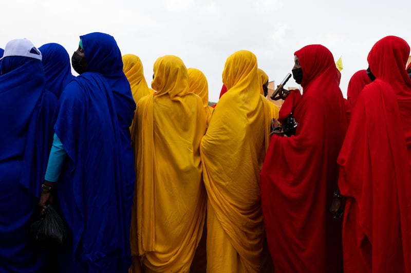 Women wait for the arrival of Mahamat Idriss Deby Itno, transitional president and candidate for the presidential election in Chad, in the stadium under construction in Moundou. AFP