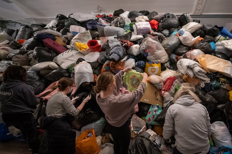 Volunteers at the Klub Orla Bialego (White Eagle Club) in Balham, south London, sift through donations on Monday made by members of the public, prior to their aid convoy setting off to Ukraine in aid of refugees fleeing the Russian invasion. PA