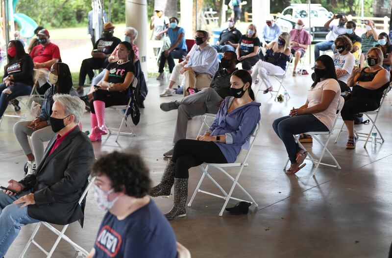 People listen as Democratic vice presidential Nominee Kamala Harris speaks at Snyder Park in Fort Lauderdale, one of several stops she made in the state on October 31, 2020. AFP