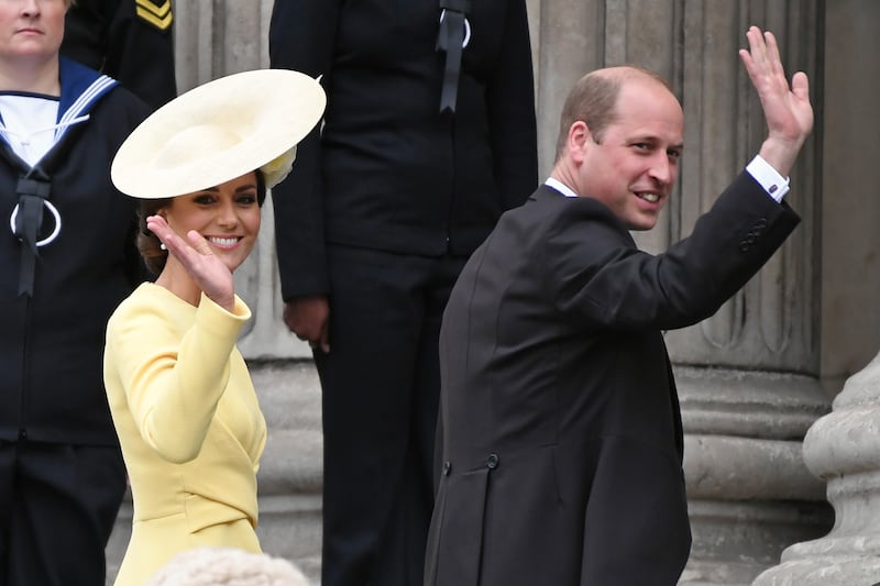 The Duchess and Duke of Cambridge wave to the crowd as they arrive at the service of thanksgiving.  Getty Images