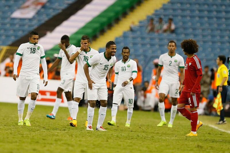 Saudi Arabia’s Nasser Al Shamrani, centre, taunts Omar Abdulrahman, right, of the UAE during last year’s Gulf Cup semi-final in Riyadh. Al Ittihad

