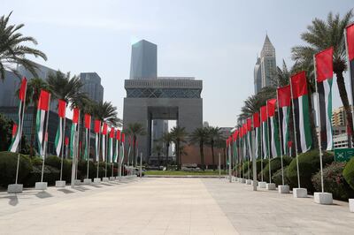 UAE flags at the DIFC area in Dubai. The UAE Central Bank expects the country's economy to grow by 5.7 per cent this year. Pawan Singh / The National