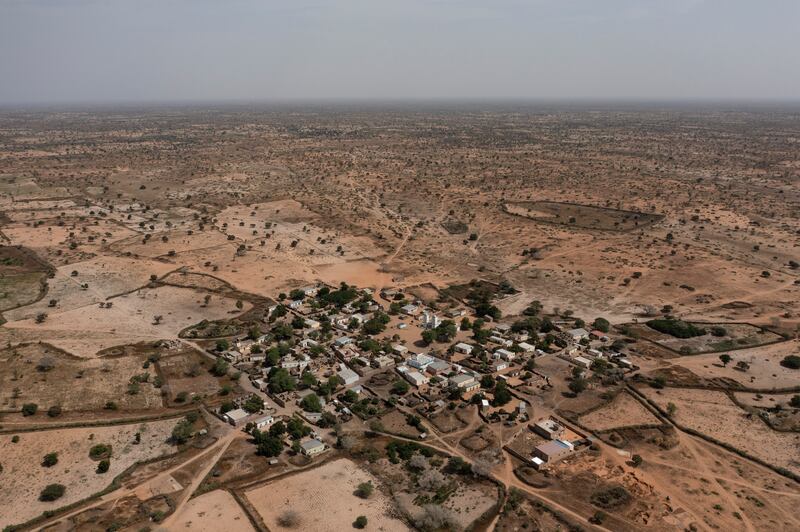 A semi-arid landscape surrounds the Sahel village of Ndiawagne Fall in Kebemer, Senegal. AP