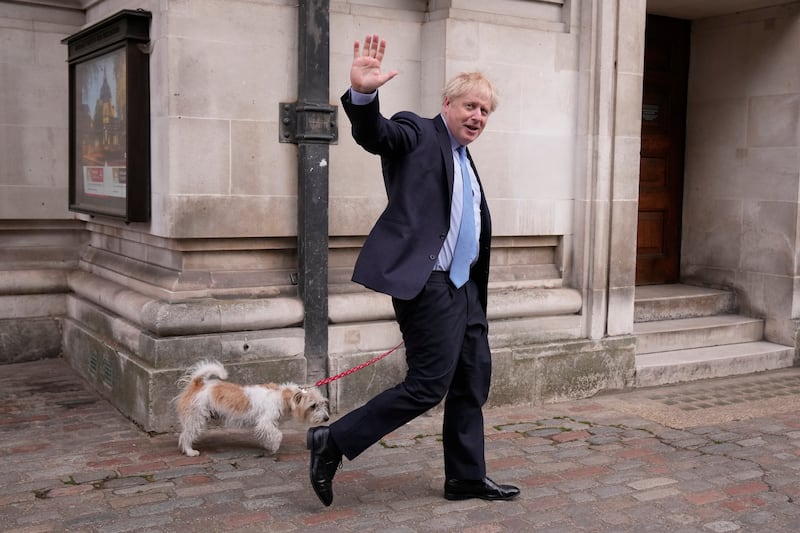 Britain's Prime Minister Boris Johnson with his dog Dilyn after voting in local council elections on May 5 at a polling station in London. AP
