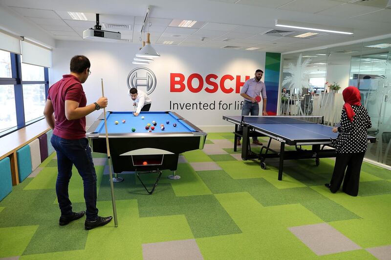 DUBAI , UNITED ARAB EMIRATES, September 12 – 2018 :- Employees playing snooker and table tennis in the recreational room at the Bosch Middle East office in Dubai Airport Free zone in Dubai. ( Pawan Singh / The National )  For News. Story by Gillian