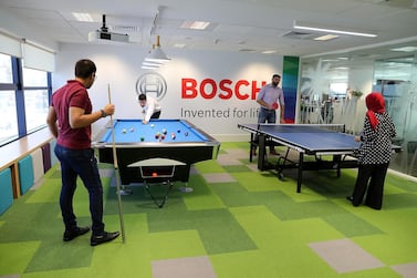 Employees playing snooker and table tennis in the recreational room at the Bosch Middle East office in Dubai. Pawan Singh / The National 
