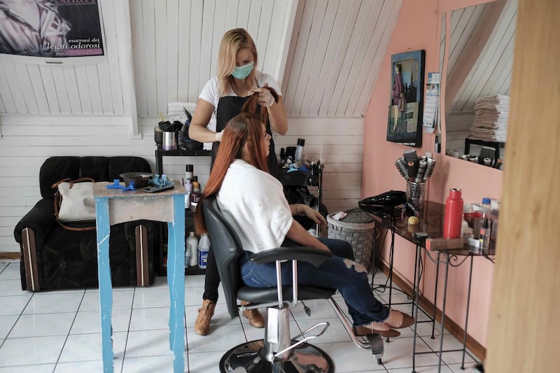 A stylist receives clients at home in San Jose, Costa Rica. The Government of Costa Rica announced  the limited opening of some activities, due to the decrease in COVID-19 cases. EPA