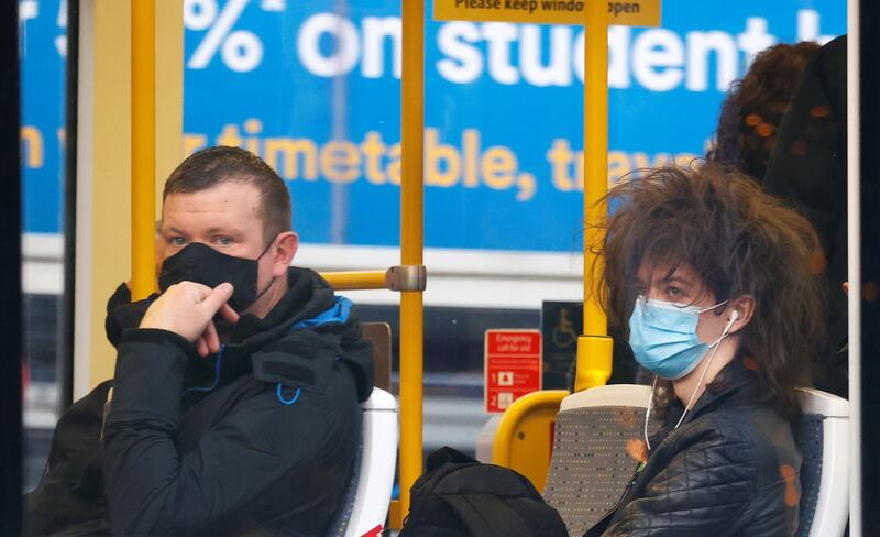 People wear protective masks as they ride on a tram in Manchester. Reuters