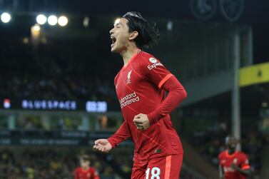NORWICH, ENGLAND - SEPTEMBER 21: Takumi Minamino of Liverpool celebrates after scoring their sides first goal during the Carabao Cup Third Round match between Norwich City and Liverpool at Carrow Road on September 21, 2021 in Norwich, England. (Photo by Stephen Pond / Getty Images)