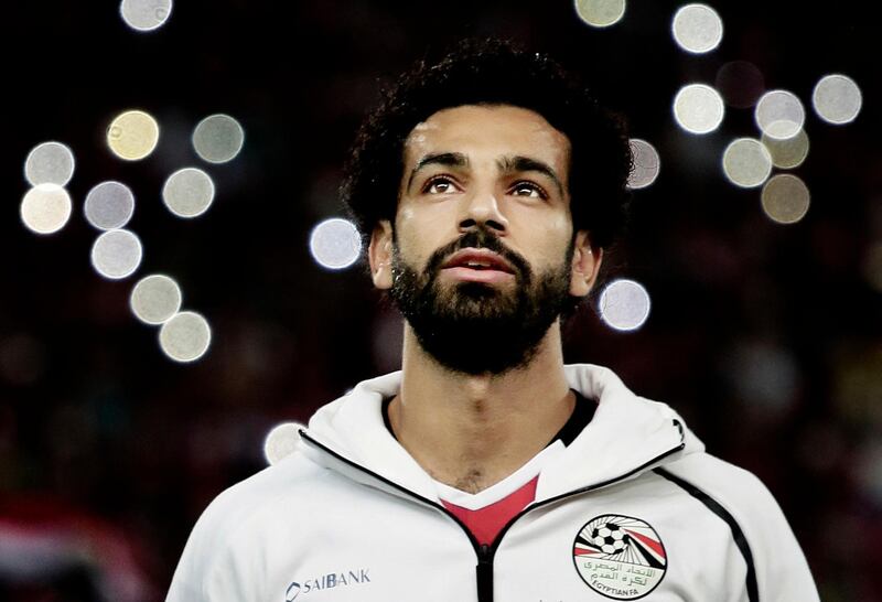 FILE - In this Oct. 8, 2017 file photo, Egypt's Mohamed Salah sings the national anthem before the 2018 World Cup group E qualifying soccer match between Egypt and Congo at the Borg El Arab Stadium in Alexandria. Egyptâ€™s first World Cup warmup will be against Portugal in a match that could have two of the most prolific scorers in soccer going up against each other. The Egyptians will be led by Liverpool forward Mohammed Salah. On the other side is Cristiano Ronaldo. (AP Photo/Nariman El-Mofty, File)