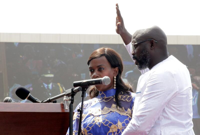 Liberia's new President George Weah raises his hand during the swearing-in ceremony at the Samuel Kanyon Doe Sports Complex in Monrovia, Liberia, January 22, 2018. REUTERS/Thierry Gouegnon