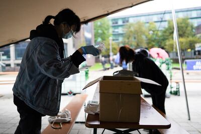 NEWCASTLE UPON TYNE, ENGLAND - OCTOBER 03: Chinese students at Northumbria University sort out care packages for other Chinese students attending the university on October 03, 2020 in Newcastle upon Tyne, England. Northumbria University has said 770 of its students have tested positive for Covid-19, in one of the UKâ€™s largest single-site coronavirus outbreaks, as other universities across the country reported surging case numbers. The Newcastle outbreak has taken the total number of cases among students to more than 2,000 across 65 universities, with most testing positive in the last week. (Photo by Ian Forsyth/Getty Images)