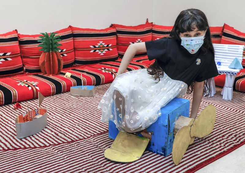 Abu Dhabi, United Arab Emirates, August 11, 2020.   ADNOC Family Education.  Alzaabi kids with their art projects.  Fatima-7 on her cardboard airplane.
Victor Besa /The National
Section: NA
Reporter:  Mustafa Alrawi