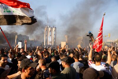 Smoke billows as protesters demonstrate in Baghdad against the burning of a Quran. Reuters 
