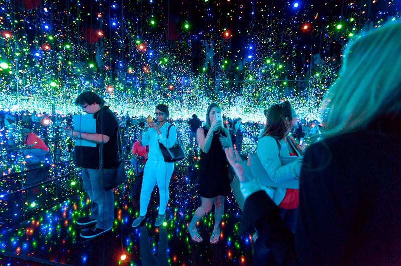 Visitors at Yayoi Kusama’s infinity room, where twinkling lights are reflected off the water and mirrored walls. Courtesy Guggenheim Abu Dhabi


