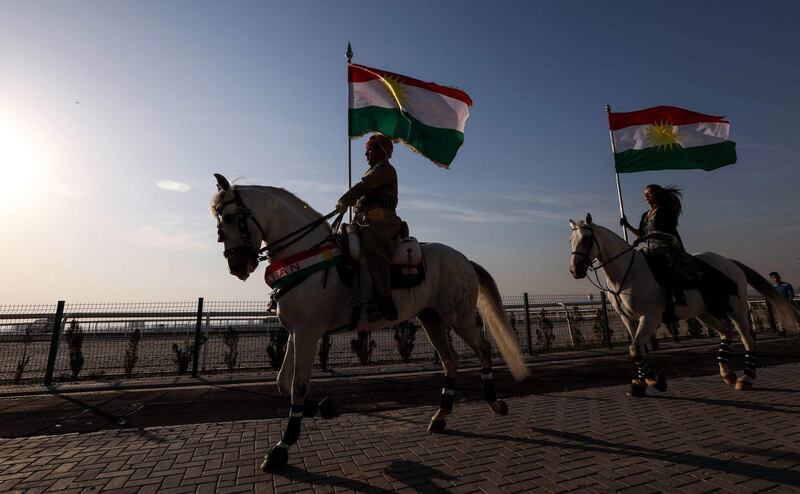 Iraqi Kurdish horsemen ride carrying Kurdish flags celebrating their flag day in the northern city of Arbil, the capital of the autonomous Kurdish region in northern Iraq, on December 17, 2017. / AFP PHOTO / SAFIN HAMED