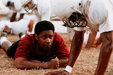 Denzel Washington portrays real-life football coach, Herman Boone, who battled racism and injustice to put together a team of black and white players in a newly desegregated Virginia school in 'Remember The Titans'. Shutterstock