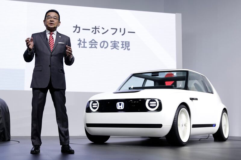 The Honda president and chief executive Takahiro Hachigo in front of the Honda Urban EV Concept at the 45th Tokyo Motor Show 2017 in Japan.  Kiyoshi Ota/EPA