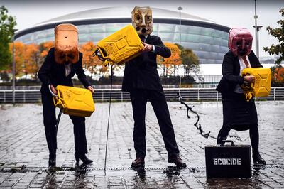 Activists from Ocean Rebellion pour fake oil in front of the Cop26 venue in Glasgow ahead of the start of the climate summit. AFP
