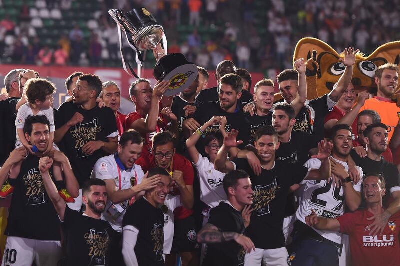 Valencia players pose with the Copa del Rey trophy. Getty