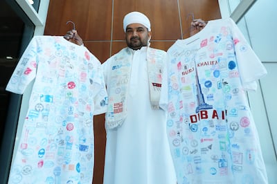 Muhammad Asim Durrani shows the kandura and T-shirt that he used to collect the Expo pavilion stamps. Pawan Singh / The National