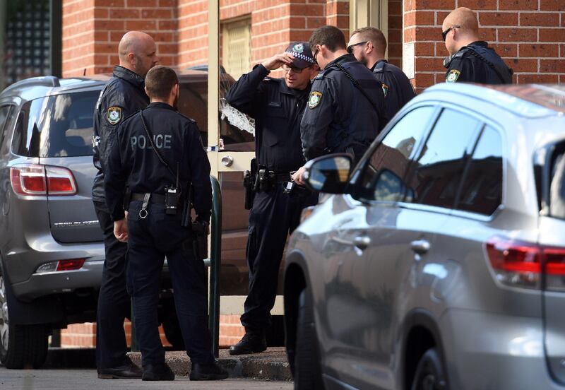 Police emerge from the block of flats in the Sydney suburb of Lakemba after a search. William West.