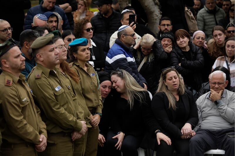 Family members and friends mourn during a funeral for Israeli soldier Lt Col Nathaniel Ya'akov Elkouby, who was killed in a battle in Haifa, Israel. AP