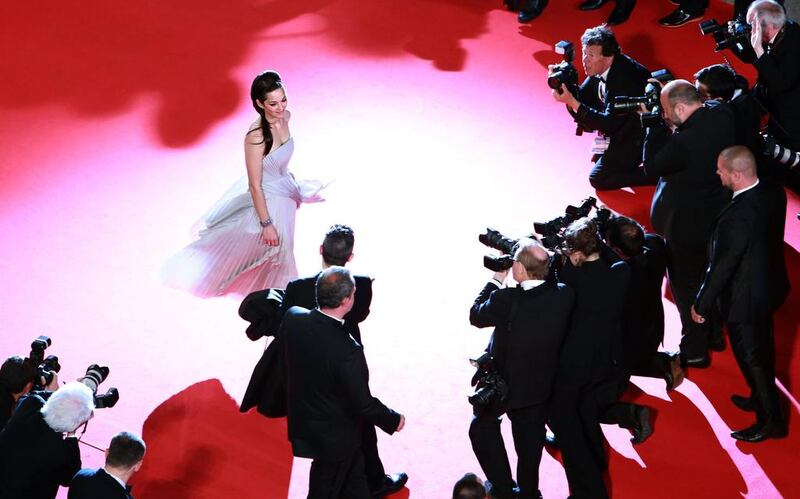 French actress Marion Cotillard poses as she arrives for the screening of the film L’Homme qu’on Aimait Trop (In the Name of my Daughter) at the Cannes Film Festival on May 21, 2014. Loic Venance / AFP