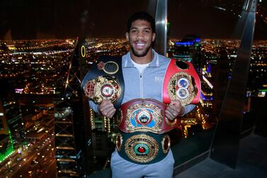 Anthony Joshua with the IBF, WBA, WBO and IBO belts after reclaiming his titles from Andy Ruiz Jr. Reuters