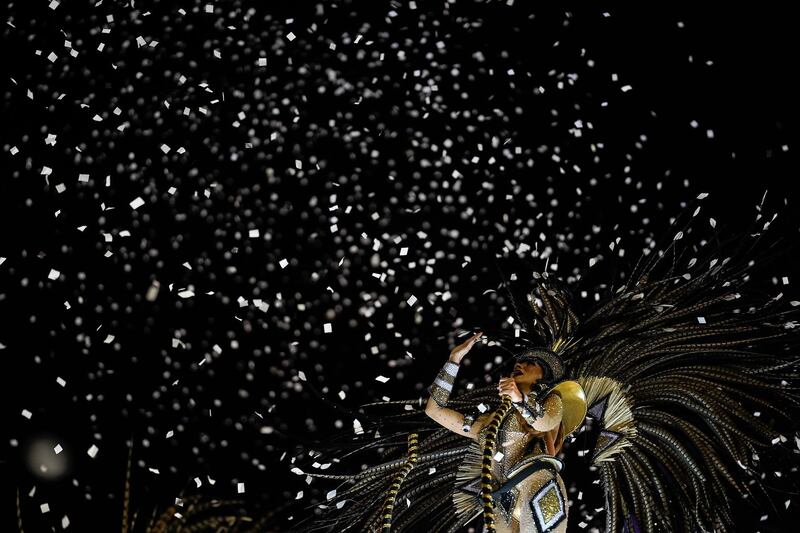 A performer from the Grande Rio samba school parades on a float. AP
