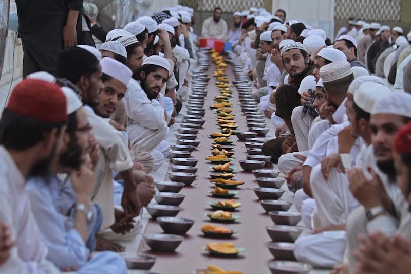 Pakistani Muslims pray before eating in the evening on the first day of Ramadan in Peshawar, Pakistan on June 29, 2014. Bilawal Arbab/EPA