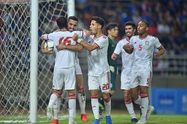 UAE players celebrate with goalscorer Ali Mabkhout during the Group G qualifier against Thailand in Thailand in October 2019. 