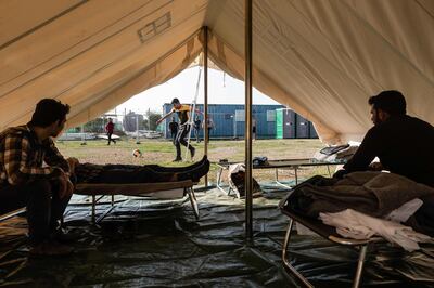 (FILES) In this file photo taken on November 05, 2019 Syrian refugees play football inside the Temporary Accommodation Centre in Kokkinotrimithia, some 20 kilometres outside the Cypriot capital Nicosia on November 5, 2019. In the thick of the coronavirus lockdown in Cyprus, authorities gave a group of asylum seekers a stark choice: move to an overcrowded camp or go home. / AFP / Iakovos Hatzistavrou
