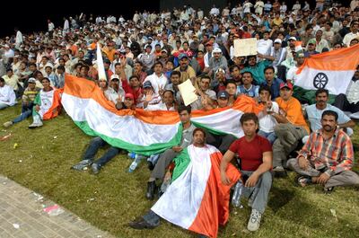 Indian supporters cheer for their team during the second Series of the DLF Cup between India and Pakistan at the Zayad Cricket Stadium in Abu Dhabi, 19 April 2006.  AFP PHOTO/HAIDER SHAH / AFP PHOTO / HAIDER SHAH