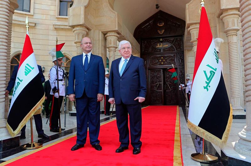 Former Iraqi President Fuad Masum, center, and newly elected Iraqi President Barham Salih, attend the inauguration ceremony in Baghdad, Iraq, Wednesday, Oct. 3, 2018. Iraq's new president is set to take office after tapping Adel Abdul-Mahdi, 76, an independent Shiite politician and former vice president for the post of prime minister. (AP Photo/Khalid Mohammed)