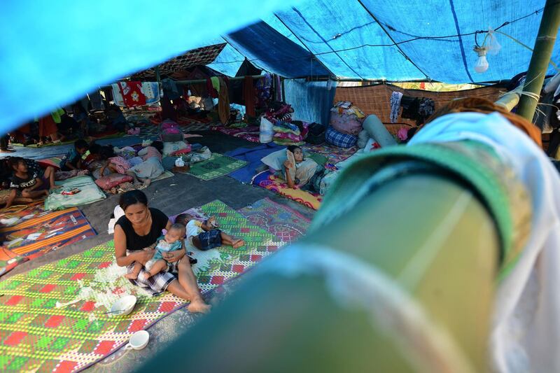 Displaced residents rest in tents set up in Kayangan in northern Lombok island.  AFP