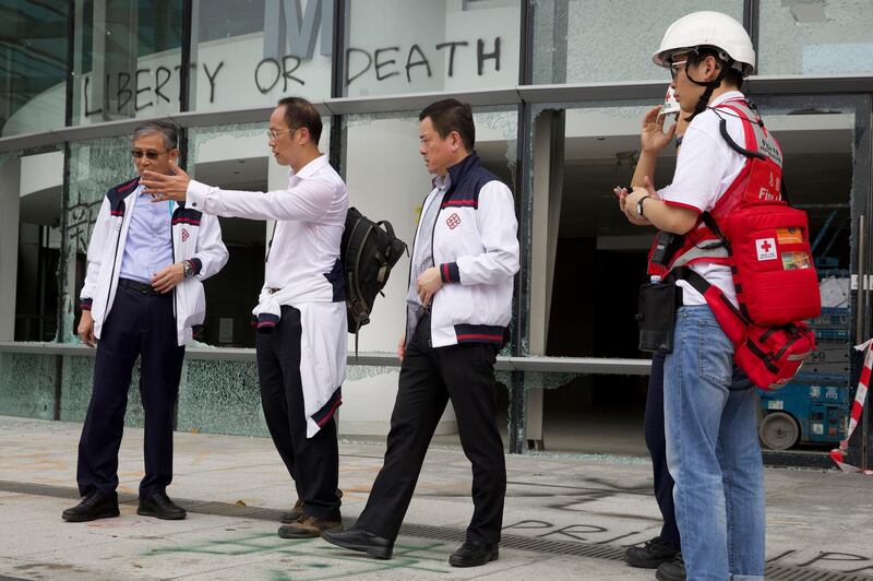 Prof. Alex Wai, second from left, a vice president with the Hong Kong Polytechnic University prepares to lead a team to look for holed up protesters on the university campus in Hong Kong. Hong Kong's embattled leader Carrie Lam refused to offer any concessions to anti-government protesters despite a local election trouncing, saying Tuesday that she will instead accelerate dialogue and identify ways to address societal grievances. AP Photo