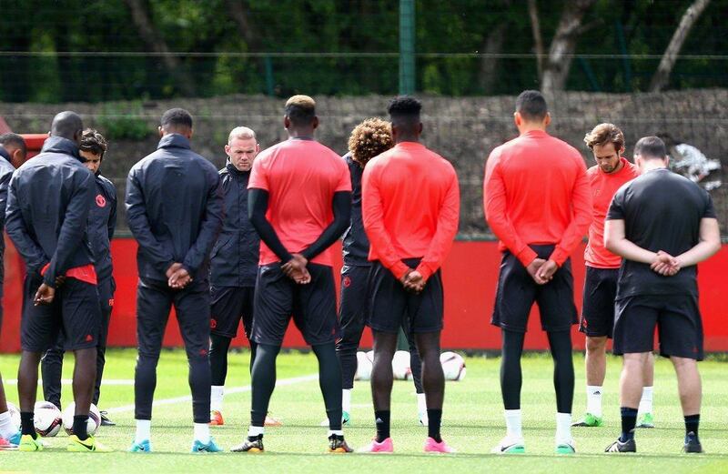 Manchester United players and staff hold a minute's silence in memory of the victims of the Manchester Concert attack during a Manchester United training session ahead of the Europa League final against Ajax at the Aon Training Complex on May 23, 2017 in Manchester, England. Dave Thompson / EPA