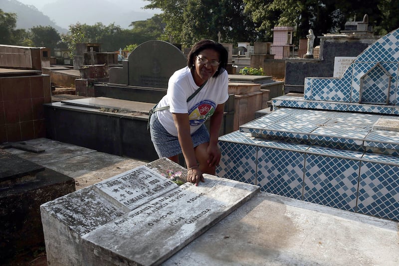 Rosangela dos Santos, the daughter of former football player Garrincha, looks over the tomb in the municipal cemetery of Raiz da Serra, Rio de Janeiro, Brazil. Marcelo Sayao / EPA