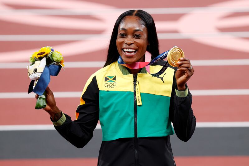 Gold medalist Elaine Thompson-Herah of Jamaica poses on the podium during the medal ceremony for the Women's 200m.