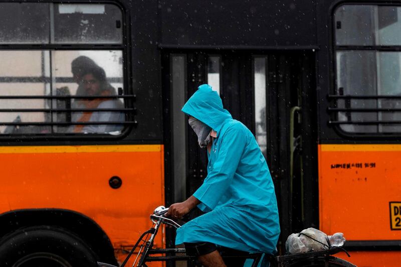 A man commutes on a bicycle during monsoon rainfalls in New Delhi, India. AFP