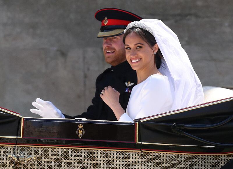 Meghan Markle and Prince Harry ride in an Ascot Landau carriage at Windsor Castle after their wedding in Windsor, Britain, May 19, 2018. Steve Parsons/Pool via REUTERS