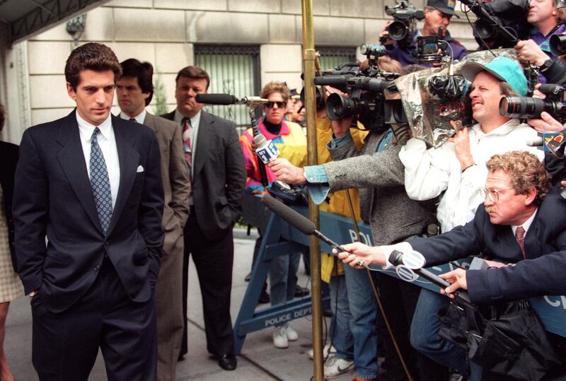 John F  Kennedy Jr answering journalists questions soon after his mother Jackie Kennedy's death in New York. AFP