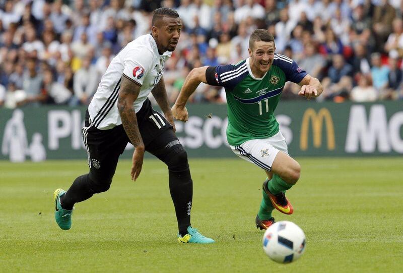 Northern Ireland's Conor Washington, right, and Germany's Jerome Boateng go for the ball during the Euro 2016 Group C soccer match between Northern Ireland and Germany at the Parc des Princes stadium in Paris, France, Tuesday, June 21, 2016. (AP Photo/Michael Probst)